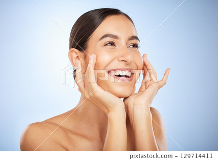 Face, beauty skincare and woman in studio isolated on a blue background. Thinking, natural makeup and cosmetics of young female model happy with spa facial treatment for healthy and glowing skin. Face, beauty skincare and woman in studio isolated on a blue background. Thinking, natural makeup and cosmetics of young female model happy with spa facial treatment for healthy and glowing skin. 129714411