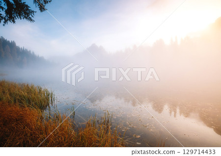Stunning image of the foggy lake Antorno in National Park Tre Cime di Lavaredo. Stunning image of the foggy lake Antorno in National Park Tre Cime di Lavaredo. 129714433