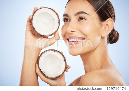 Skincare, wellness and face of woman with coconut on blue background for dermatology, body care and beauty. Spa, salon and girl with fruit for natural beauty products, cosmetics and facial treatment Skincare, wellness and face of woman with coconut on blue background for dermatology, body care and beauty. Spa, salon and girl with fruit for natural beauty products, cosmetics and facial treatment 129714474