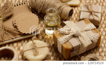 Handmade soap bars on marble stand and packaging items on table 129714529