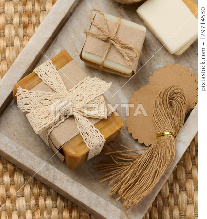 Pieces of handmade soap on a marble stand 129714530
