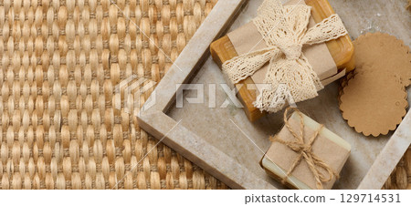 Pieces of handmade soap on a marble stand 129714531