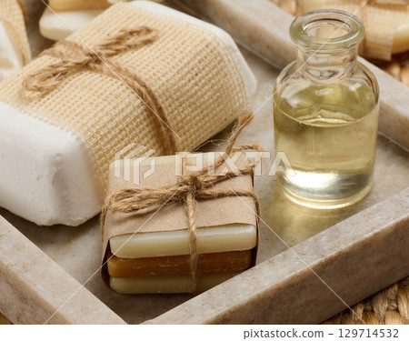 Pieces of handmade soap on a marble stand 129714532