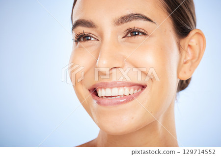 Skincare model face, smile and beauty by blue background for wellness, radiant glow and cosmetics. Woman, studio background and happy for self care, cosmetic and soft facial skin for aesthetic shine Skincare model face, smile and beauty by blue background for wellness, radiant glow and cosmetics. Woman, studio background and happy for self care, cosmetic and soft facial skin for aesthetic shine 129714552