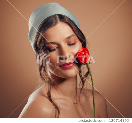 Rose, woman and face for beauty, natural skincare and cosmetics for floral perfume, aesthetic and eco makeup on studio background. Headshot, model and flowers of nature, spring plants and body glow Rose, woman and face for beauty, natural skincare and cosmetics for floral perfume, aesthetic and eco makeup on studio background. Headshot, model and flowers of nature, spring plants and body glow 129714593