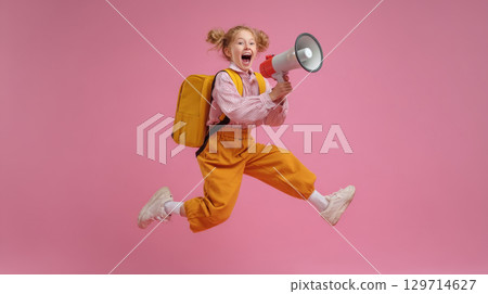 Joyful schoolgirl with a backpack jumping high and shouting into a megaphone. A happy and energetic child celebrates the beginning of the school year, expressing enthusiasm and excitement Joyful schoolgirl with a backpack jumping high and shouting into a megaphone. A happy and energetic child celebrates the beginning of the school year, expressing enthusiasm and excitement 129714627