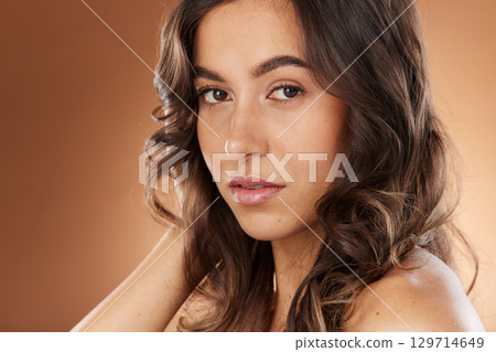 Woman, face skincare or curly hairstyle on studio background in Brazilian keratin treatment, self love or healthcare wellness. Portrait zoom, brunette color or beauty model and natural texture waves 129714649