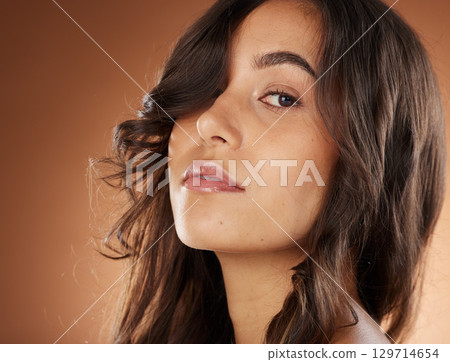 Woman, face skincare or curly hairstyle on studio background in Brazilian keratin treatment, self love or healthcare wellness. Portrait zoom, brunette color or beauty model and natural texture waves 129714654