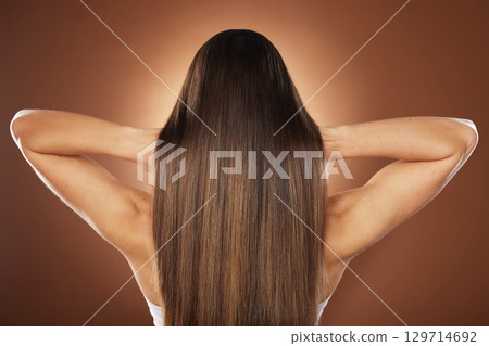 Woman, back or hair style on brown background in relax studio for keratin treatment, self care wellness or color dye routine. Model, texture or brunette growth aesthetic with balayage transformation Woman, back or hair style on brown background in relax studio for keratin treatment, self care wellness or color dye routine. Model, texture or brunette growth aesthetic with balayage transformation 129714692