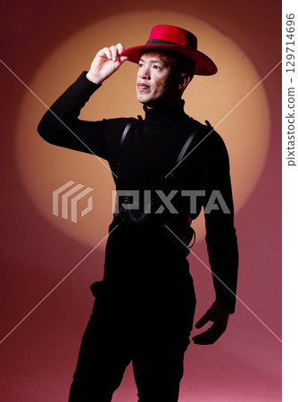 Fashion, style and man with vitiligo in a studio with a grungy, edgy and goth outfit with an orange light. Stylish, aesthetic and cool male model with a skin depigmentation posing by a red background Fashion, style and man with vitiligo in a studio with a grungy, edgy and goth outfit with an orange light. Stylish, aesthetic and cool male model with a skin depigmentation posing by a red background 129714696