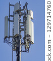 Telecommunication tower stands tall against a clear blue sky, broadcasting signals for mobile communication and internet connectivity, ensuring seamless communication in the modern world 129714760