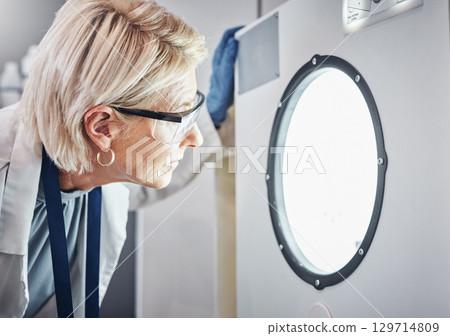 Scientist, worker or laboratory autoclave equipment in medical research, vaccine temperature control or dna engineering. Zoom, thinking face or mature woman or science centrifuge machine for medicine 129714809