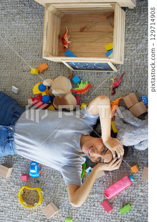 Stress, mother or toys in messy living room for spring cleaning, housekeeping or tidy maintenance in top view. Anxiety, mental health or burnout mom and children play objects in Brazilian family home Stress, mother or toys in messy living room for spring cleaning, housekeeping or tidy maintenance in top view. Anxiety, mental health or burnout mom and children play objects in Brazilian family home 129714908