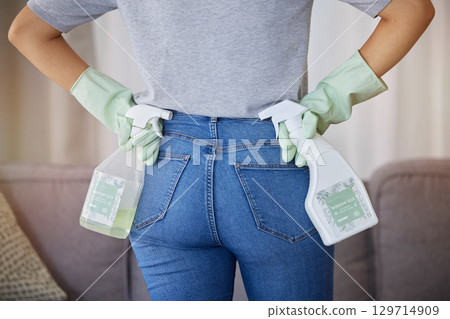 Cleaning, housework and woman from back with spray bottle and gloves in in living room at home. Spring cleaning, hygiene and bottle of soap or sanitizer to clean dirty sofa, housekeeper in apartment. 129714909