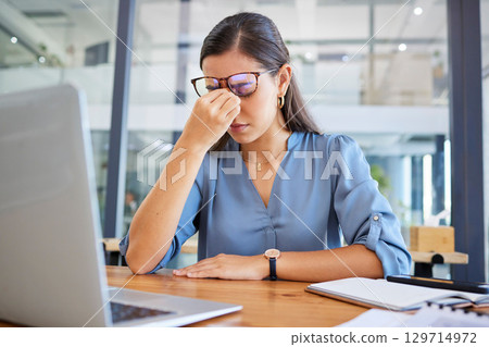 Stress headache, burnout and woman in office overwhelmed with workload at desk with laptop. Frustrated, overworked and tired woman with computer at startup, anxiety from deadline time pressure crisis 129714972