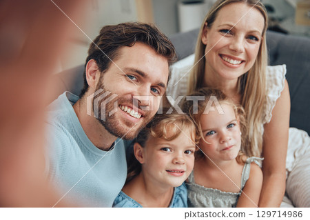 Family, selfie and home of a mother, dad and girl children on a living room sofa with love and care. Parents, kids and mama with father on a couch with a happy smile bonding together in a lounge 129714986