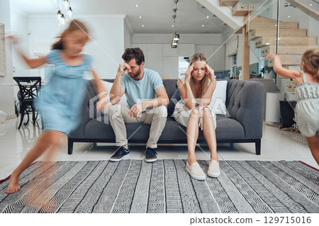 Tired parents, child energy and parent care burnout with anxiety from adhd children at home. Headache, stress and noise from girl kids in a living room busy with mom and dad on a sofa with fatigue 129715016