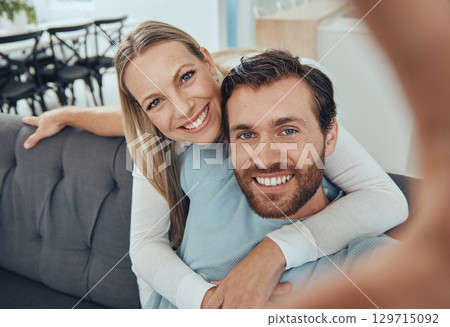 Love, selfie and couple on sofa, smile and bonding for relationship, weekend break and romance. Portrait, man and woman loving, romantic and hug for social media, dating and share pictures on couch. 129715092