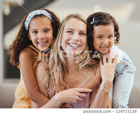Adoption, family and portrait of mother with kids in home, bonding and hugging. Love, care and mom with foster girls, embrace and smiling while enjoying quality time together on sofa in living room. Adoption, family and portrait of mother with kids in home, bonding and hugging. Love, care and mom with foster girls, embrace and smiling while enjoying quality time together on sofa in living room. 129715138