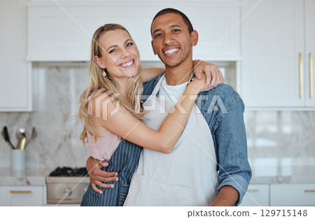 Kitchen, couple and hug portrait with love, care and smile at home ready for meal cooking. Interracial happy couple loving marriage, diversity and diet nutrition in a house hungry for food together 129715148