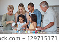 Baking, big family and kitchen cooking of grandparents, parents and girl children learning. Home, kids and interracial family with love, parent care and senior grandparent in a house making food 129715171