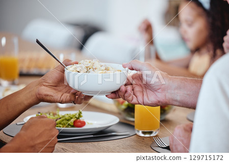 Food, lunch and hands pass bowl with delicious pasta at home. Brunch, fine dining and family or people eating and sharing a tasty, gourmet and healthy meal on table together in house dinning room 129715172