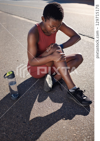 Fitness, knee and black woman injury, after training and workout with agony, emergency and outdoor. African American female, runner and athlete with pain, suffering and discomfort on road and hurt. 129715178