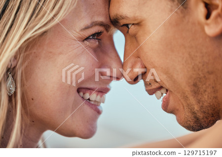 Love, diversity and couple with heads together, smile and affection touching and eye contact. Romance, trust and support woman and man touch forehead, happy couple in romantic embrace on honeymoon. Love, diversity and couple with heads together, smile and affection touching and eye contact. Romance, trust and support woman and man touch forehead, happy couple in romantic embrace on honeymoon. 129715197