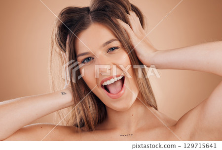 Woman, beauty and smile for hair, skincare or treatment against a brown studio background. Portrait of happy and excited female smiling in happiness or satisfaction for perfect skin or facial care Woman, beauty and smile for hair, skincare or treatment against a brown studio background. Portrait of happy and excited female smiling in happiness or satisfaction for perfect skin or facial care 129715641