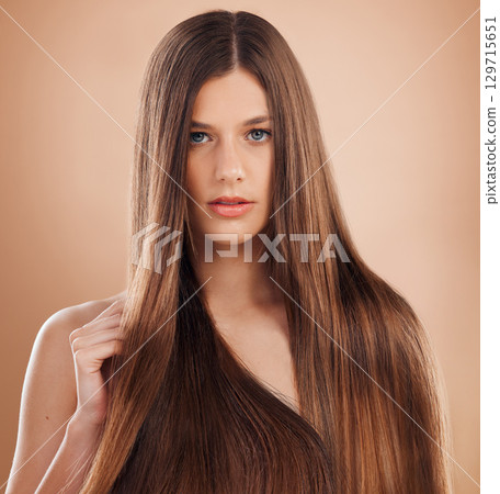 Hair, salon and portrait of woman in studio on orange background for wellness, beauty and cosmetics. Hair care, beauty salon and face of girl with luxury treatment for healthy, natural and long hair Hair, salon and portrait of woman in studio on orange background for wellness, beauty and cosmetics. Hair care, beauty salon and face of girl with luxury treatment for healthy, natural and long hair 129715651