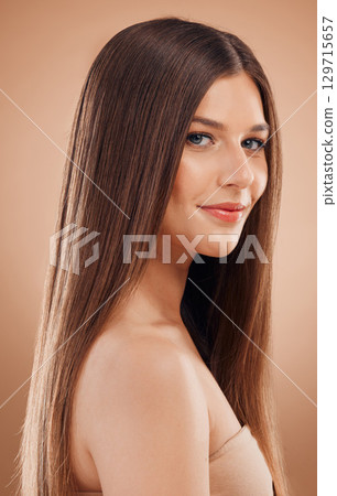 Woman, beauty and hair in studio with shine, glow and rich keratin aesthetic, textures or color on brown background. Model portrait, hair care and cosmetics, makeup salon or shampoo product of growth Woman, beauty and hair in studio with shine, glow and rich keratin aesthetic, textures or color on brown background. Model portrait, hair care and cosmetics, makeup salon or shampoo product of growth 129715657