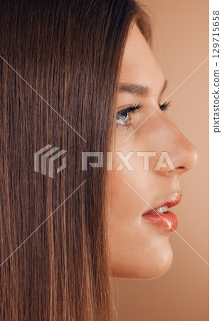 Hair, beauty and face profile of woman in studio on brown background for beauty products, makeup and cosmetics. Spa, salon aesthetic and side profile of girl for treatment, healthy skin and hair care 129715658