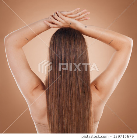 Woman, hair and beauty in cosmetics studio with long hair, treatment and self care by brown background. Model, natural hair care and balayage for cosmetic, extension or wig by studio background 129715679