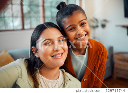 Portrait, mother and girl take a selfie for social media content as a happy family at home during holiday vacation. Face, photography or Indian mom taking pictures with a fun child for social network 129715744