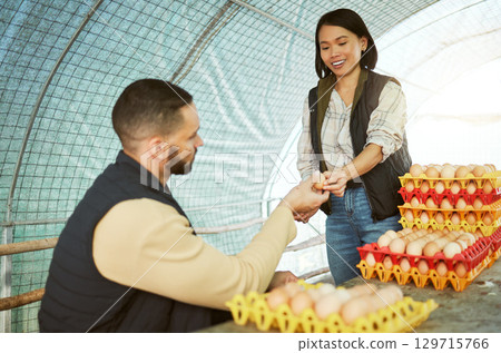 Egg farmer, food and couple at chicken farm checking health, production or growth of eggs. Poultry agriculture, sustainability or inspection of protein products with happy man and Asian woman in barn Egg farmer, food and couple at chicken farm checking health, production or growth of eggs. Poultry agriculture, sustainability or inspection of protein products with happy man and Asian woman in barn 129715766