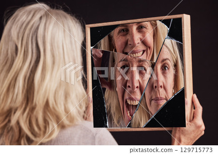 Bipolar woman, broken mirror or reflection of anxiety, depression or psychology, identity crisis or schizophrenia. Depressed face, sad or mature female with mental health, problem or black background Bipolar woman, broken mirror or reflection of anxiety, depression or psychology, identity crisis or schizophrenia. Depressed face, sad or mature female with mental health, problem or black background 129715773