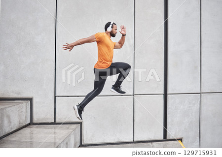 Fitness, running and man with headphone on stairs for exercise, workout and wellness, body goals and health on music app. Sports, athlete or runner jump or run listening to audio and training in city Fitness, running and man with headphone on stairs for exercise, workout and wellness, body goals and health on music app. Sports, athlete or runner jump or run listening to audio and training in city 129715931