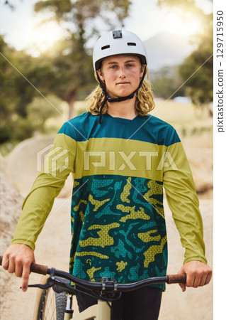 Mountain bike, portrait and man in nature or park for outdoor training, sports competition or fitness goals in Canada with youth lifestyle. Athlete cycling with bicycle and safety helmet for exercise 129715950