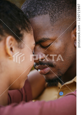 Love, intimate and black couple hugging on a date for romance, care and intimacy together. Romantic, loving and young African man and woman embracing on a summer honeymoon vacation, holiday or trip. 129715997