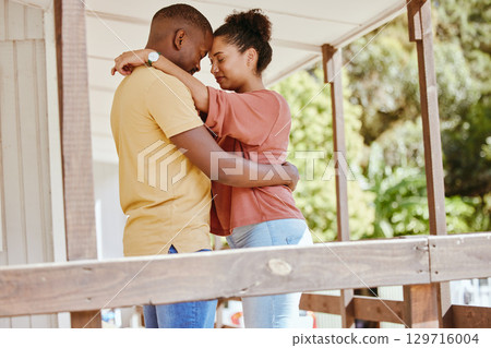 Hug, love and black couple with care, peace and praying on the porch of their house together in New Zealand. Trust, relax and African man and woman with gratitude, affection and calm at their home 129716004