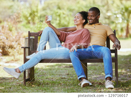 Phone, relax or couple taking a selfie in a park for a lovely date in a natural environment for fresh air. Nature, profile picture or happy black woman taking social media pictures with a black man Phone, relax or couple taking a selfie in a park for a lovely date in a natural environment for fresh air. Nature, profile picture or happy black woman taking social media pictures with a black man 129716017