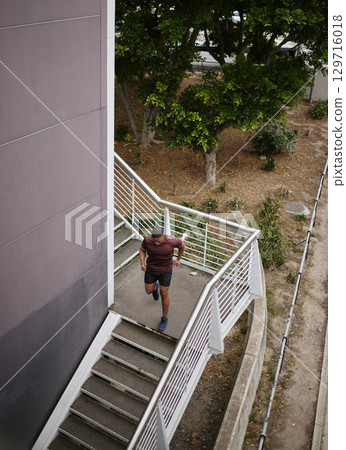 Running, fitness and training with man on stairs for sports, workout and cardio endurance. Mindset, challenge and focus with runner on steps of building for speed, exercise and sports marathon Running, fitness and training with man on stairs for sports, workout and cardio endurance. Mindset, challenge and focus with runner on steps of building for speed, exercise and sports marathon 129716018