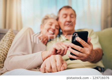 Relax, search and phone with old couple on sofa for communication, social media and internet. Bonding, rest and quality time with man and woman in home living room for digital, technology and mobile 129716076