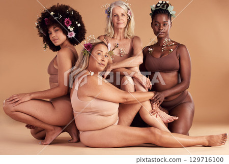 Portrait, flowers and group of women in lingerie in studio isolated on brown background. Floral cosmetics, organic makeup and body positive friends in underwear with plant product for beauty skincare 129716100