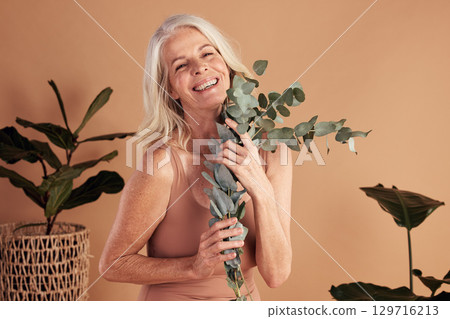 Senior, woman and beauty with leaves for skincare, nature and organic product for wellness on studio background. Happy, natural green cosmetics and plant aesthetic, dermatology for antiaging portrait Senior, woman and beauty with leaves for skincare, nature and organic product for wellness on studio background. Happy, natural green cosmetics and plant aesthetic, dermatology for antiaging portrait 129716213