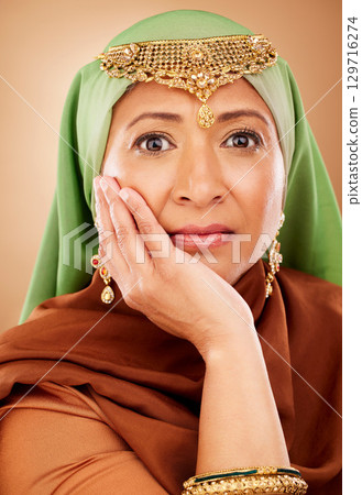 Portrait, muslim and beauty with a model woman in studio on a beige background for skincare or tradition. Face, fashion and culture with an attractive maturre islamic female proud of her heritage 129716274