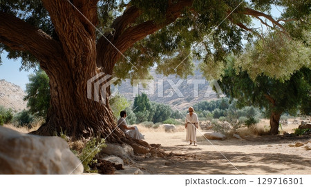 Serene outdoor meeting of two adult men under large tree. 129716301