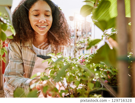Garden, plants and woman at a nursery for inspection, gardening entrepreneurship and happy in nature. Small business, flowers and woman or florist shopping at an outdoor store for a plant or flower 129716328