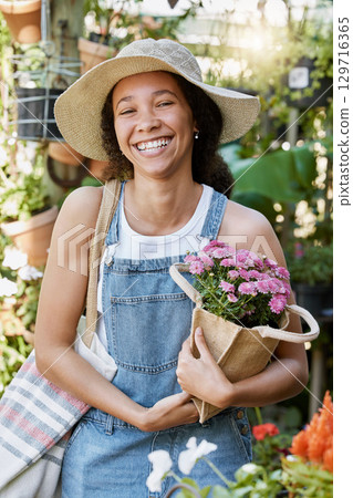 Flowers, shopping and woman at a nursery with a smile for nature, spring sustainability and growth of plants in a garden. Gardening, ecology and portrait of a happy customer at a floral shop 129716365