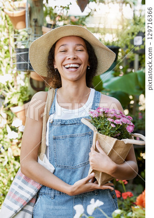 Flowers, happy and woman at a plant nursery shopping for floral products for her garden in nature. Happiness, smile and young female florist from Mexico buying a flower bouquet at sustainable market. 129716366